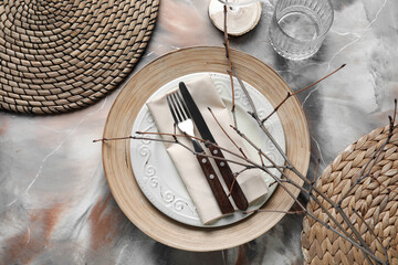 Beautiful table setting with tree branches on grunge background