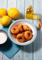 Traditional recipe of grandmother's fried doughnuts with sugar, lemon and cinnamon. Traditional Andalusian pastries.