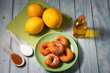 Top view of homemade doughnuts fried with sugar and cinnamon on a wooden background.