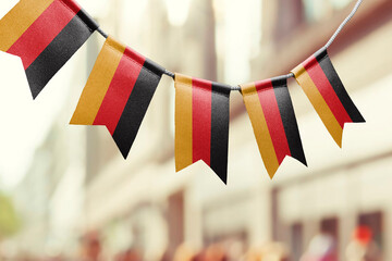 A garland of Germany national flags on an abstract blurred background © butenkow