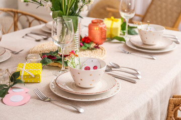 Table setting for International Women's Day celebration with daisy flowers in dining room