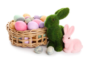 Easter bunnies and wicker basket with painted eggs isolated on white background