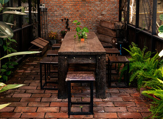 Fototapeta na wymiar Outdoor retro wooden table and chair in garden