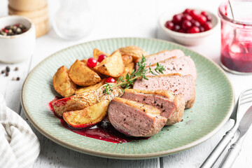 Duck breast steak with potatoes and berry sauce