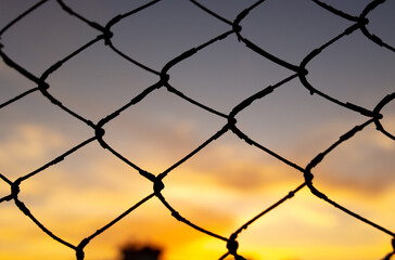 Fence mesh at sunset. Background