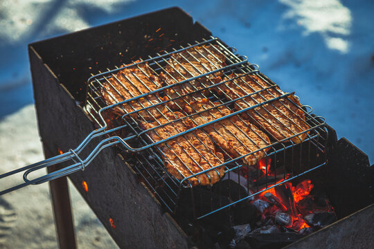Meat on the grill, on a winter sunny day in nature