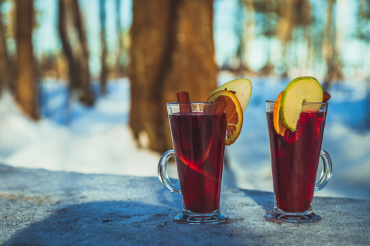 Mulled wine in glasses, orange, apple, cinnamon
