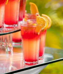 Red juicy cocktail with orange in cafe.