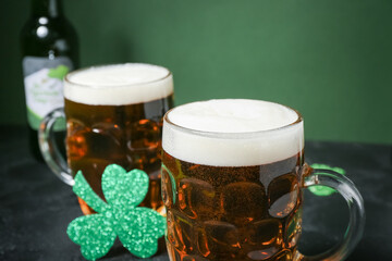 Glasses of beer on dark table, closeup. St. Patrick's Day celebration