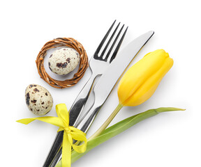 Cutlery with Easter eggs and tulip flower isolated on white background
