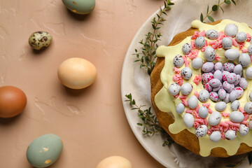 Composition with tasty Easter cake, eucalyptus branches and eggs on color background, closeup