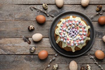 Composition with tasty Easter cake and eggs on wooden background