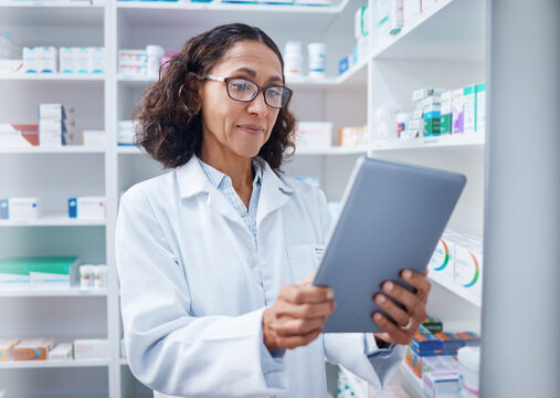 Senior woman, tablet and pharmacist in pharmacy for healthcare or stock check online in drugstore. Medication, telehealth technology and female medical doctor with touchscreen for research in shop.