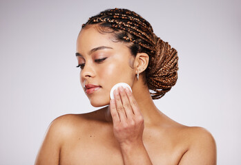 Skincare, beauty or woman with cotton pad for dermatology, wellness and healthy skin on studio background. Spa aesthetic, beauty and face of girl with swab for makeup, facial treatment and cosmetics © Nina Lawrenson/peopleimages.com