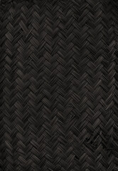 Black woven bamboo mat texture. Vertical background