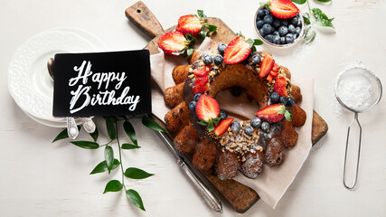 Pound Cake cake with strawberry, close-up on the table. Horizontal view from above..Pound Cake cake with mint and strawberry close-up on the table. Horizontal view from above.
