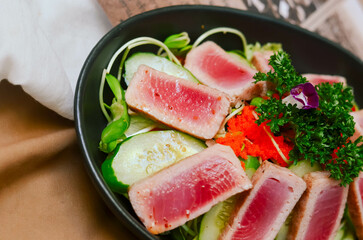Fresh Tuna Salad Served with Cucumber Roe and Tomato Lettuce Garnished with Salad and Sesame Oil Sauce