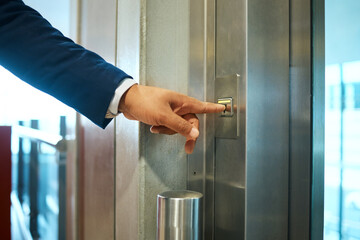 Elevator button, business man hand and office building lift for corporate finance company. Businessman, financial worker and ceo pressing down or up with hands to start working on accounting floor