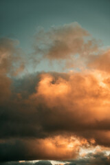 Cumulus sunset clouds with the sun setting down. Amazing sky summer evening background.