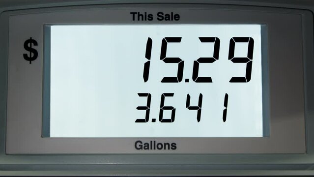 4K footage close-up of display with gas price counter in US dollars. The increase in the price per gallon on the screen as fuel enters the car's tank. Gasoline pump meter at a gas station. Sale price.
