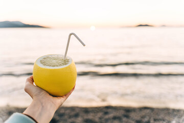 Citrus fruit with paper tube on sunset background