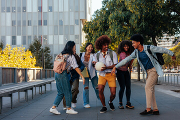 Fototapeta premium Cheerful students socializing in city.