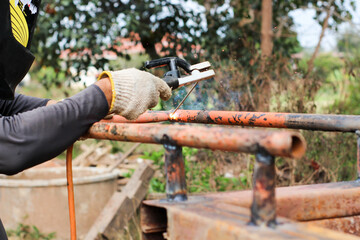 Welding steel that produces smoke and sparks.