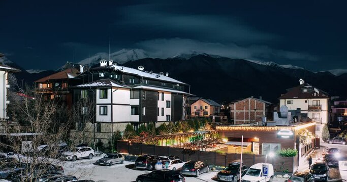 Timelapse at snowy night in Bansko with hotels and mountain in background