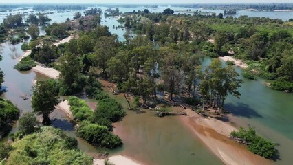 Drone footage above Koh Han island a beautiful gem in the Mekong River, Stung Treng province, Cambodia, amazing flooded forest and sand 