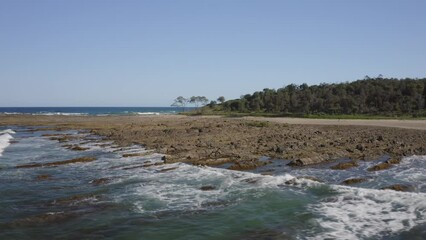 Wooli Headland NSW aerial shot over the water. Low level flight tracking left . 4k MavicPro 2 DJI