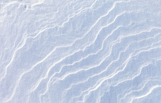 White abstract natural blured background of snowy ice sea surface on cold winter day. Frozen snow waves texture. Wmpty space for text. Top view, flat lay, copy space, mock up, blank