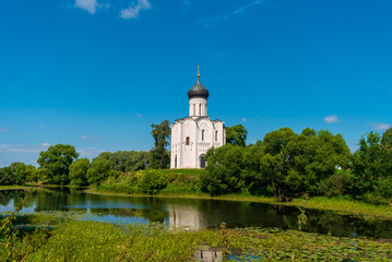 Fototapeta na wymiar View of Church of the Intercession on the Nerl on summer day. Temple in the Vladimir region of Russia, built in the 12th century.