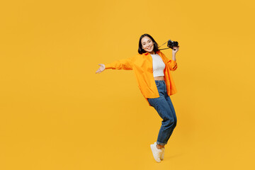 Fototapeta na wymiar Young woman wear summer clothes stand on toes with outstretched hands lean back isolated on plain yellow background. Tourist travel abroad in free time rest getaway. Air flight trip journey concept.