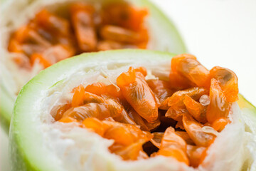 Green Passionfruit also called Maracuya or Passiflora cut in half macro shots. Fresh edible pulp of passion fruit	extreme close up
