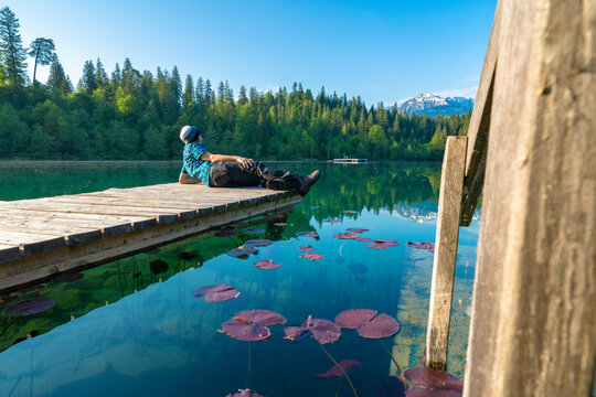 Man relaxing looking at Crestasee lake, Flims, Switzerland