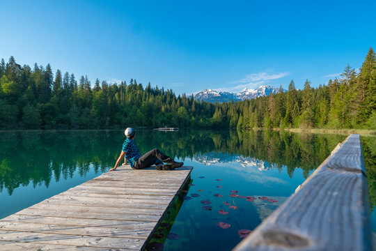Man relaxing looking at Crestasee lake, Flims, Switzerland