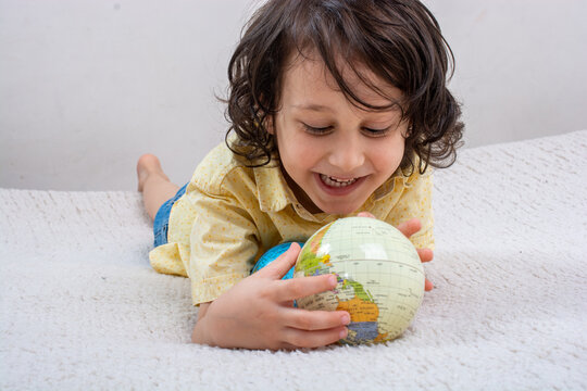 Happy preschooler boy discovering world as back to school concep