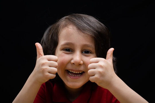 Happy boy showing thumbs up. Happiness child showing sign ok
