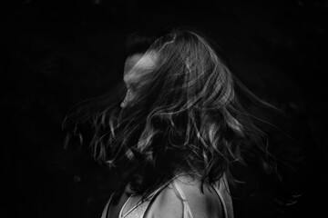 Black and white portrait of a female swishing hair