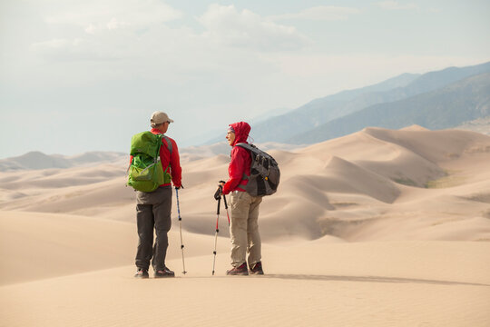 Senior couple talk and enjoy view of sand dunes