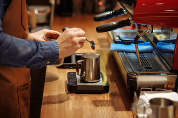 The bartender prepares coffee at the coffee machine