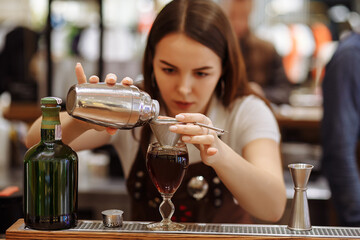 Bartender girl prepares coffee drinks