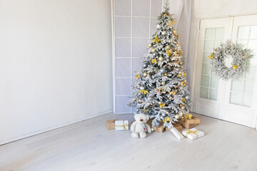 new year christmas tree with wreath gifts in bright christmas room