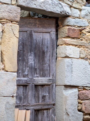 Fototapeta na wymiar A beautiful rustic wooden door in a town