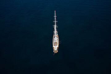 Large sailing yacht, top view. Anchorage sailing yacht on dark water top view.