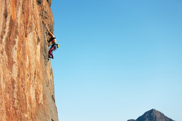the girl is engaged in rock climbing. sports in nature.