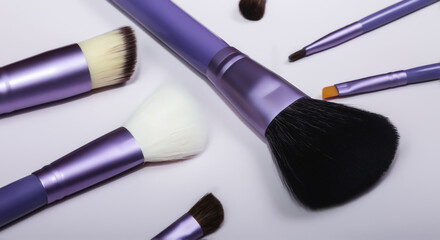 Set of makeup brushes on a colored background. Top view point, flat lay.