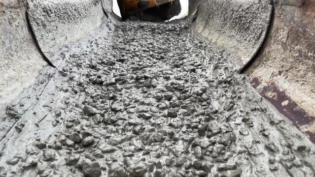 Pouring concrete mix on concreting formwork. Slow Motion
