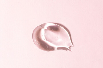 Swatches from various cosmetic products, drops of lotion, smears of creams, gels and scrubs on pink...