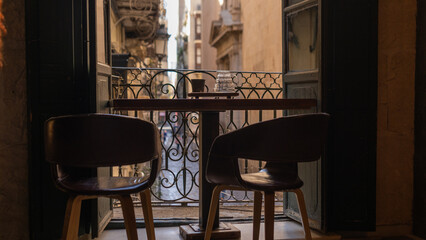 View of cozy spanish street through a cafe window
